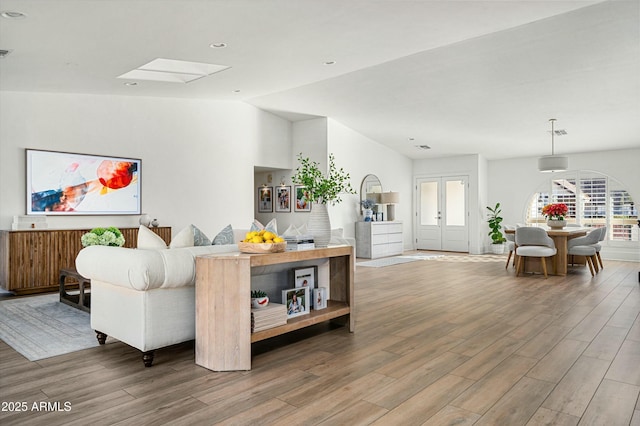 living room featuring wood-type flooring and french doors