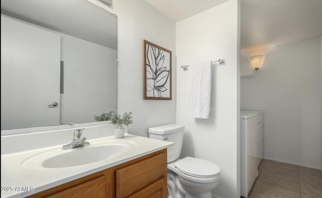 3511 E Baseline Rd Unit 1235, Phoenix, AZ 85042 - bathroom with toilet, washer and clothes dryer, vanity, and tile patterned flooring