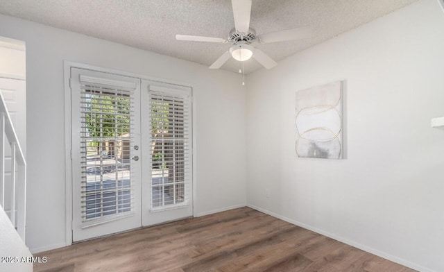 3511 E Baseline Rd Unit 1235, Phoenix, AZ 85042 - spare room featuring wood finished floors, french doors, a textured ceiling, a ceiling fan, and baseboards