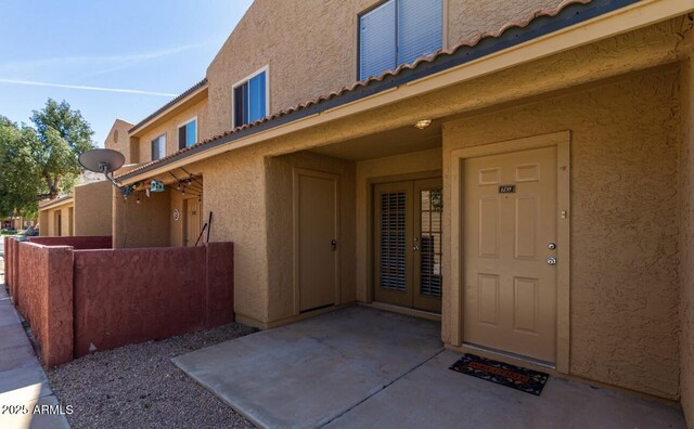 3511 E Baseline Rd Unit 1235, Phoenix, AZ 85042 - entrance to property with french doors, stucco siding, fence, and a tile roof