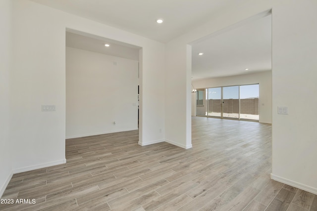 unfurnished room with light wood-type flooring