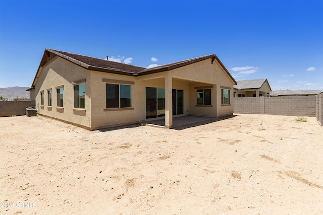 rear view of house with a patio and central air condition unit