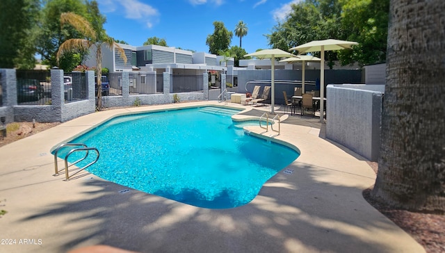 view of swimming pool with a patio area