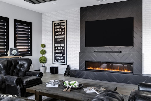 living area featuring wood finished floors and a fireplace