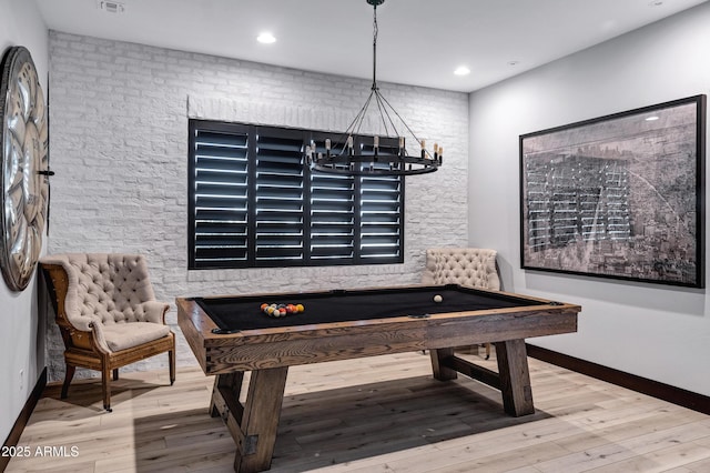 rec room featuring wood finished floors, a chandelier, and pool table
