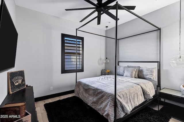 bedroom with light wood finished floors and a ceiling fan