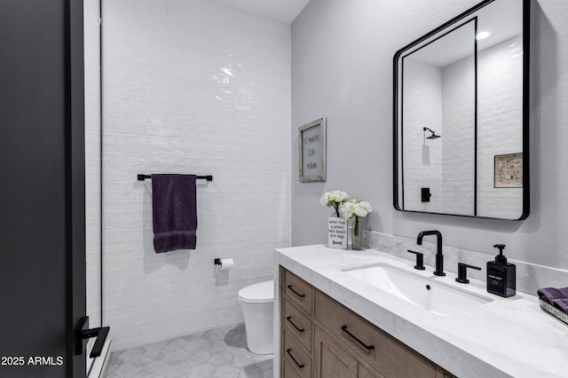 full bathroom with toilet, vanity, and tile patterned flooring