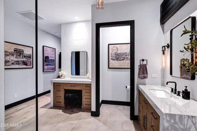 full bathroom with a sink, visible vents, baseboards, two vanities, and wood finished floors