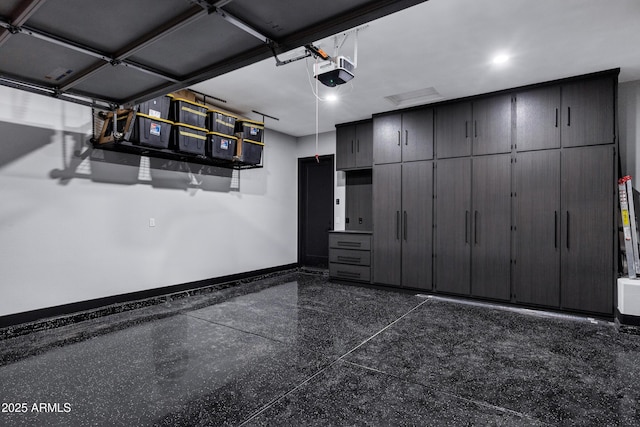 garage with a garage door opener and baseboards