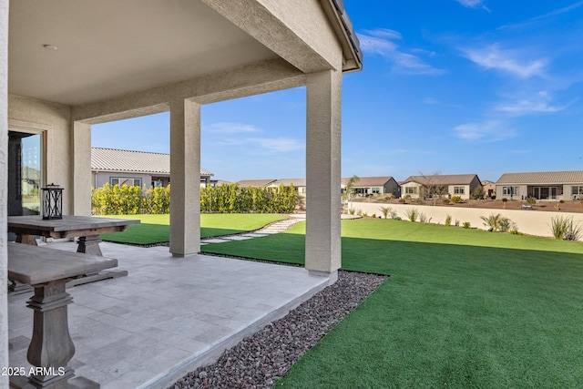 view of yard with a residential view and a patio area