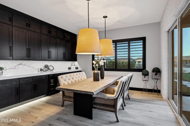 dining room featuring baseboards and light wood-style floors
