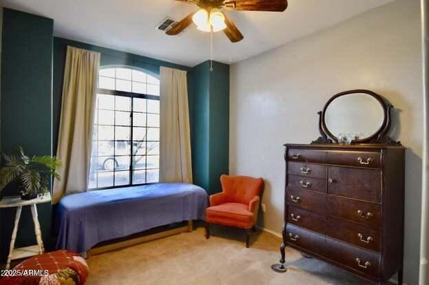 carpeted bedroom featuring visible vents and ceiling fan