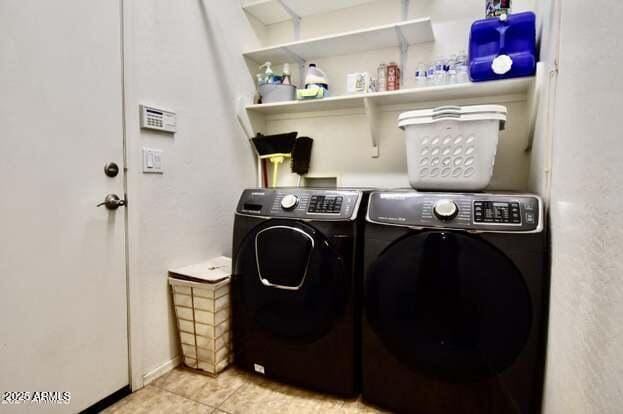 laundry area with light tile patterned floors, laundry area, and washer and dryer