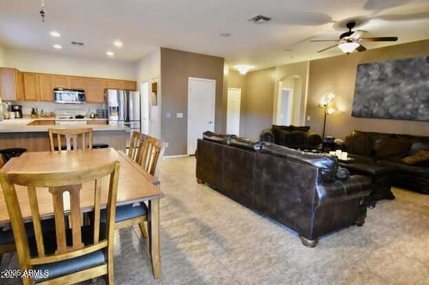 living area featuring visible vents, recessed lighting, and a ceiling fan