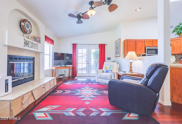 living area featuring french doors, a ceiling fan, vaulted ceiling, wood finished floors, and recessed lighting