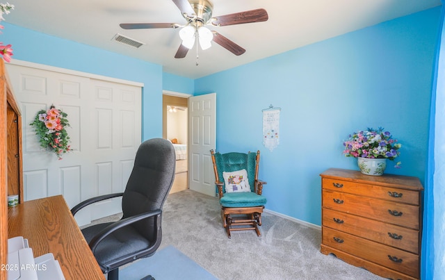carpeted office with baseboards, ceiling fan, and visible vents