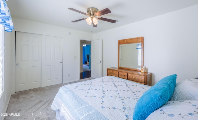 carpeted bedroom with ceiling fan and a closet