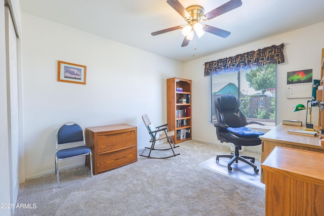 office featuring baseboards, a ceiling fan, and carpet