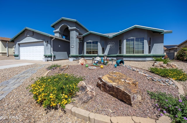 single story home featuring an attached garage, driveway, and stucco siding