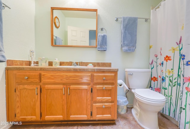 bathroom with vanity, tile patterned floors, toilet, and a shower with curtain