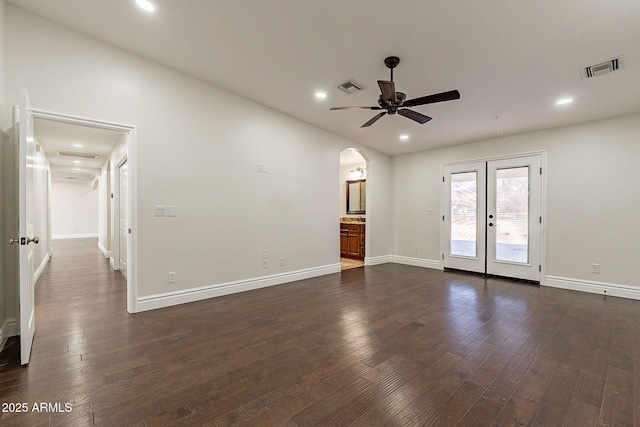 empty room with dark hardwood / wood-style floors, ceiling fan, and french doors