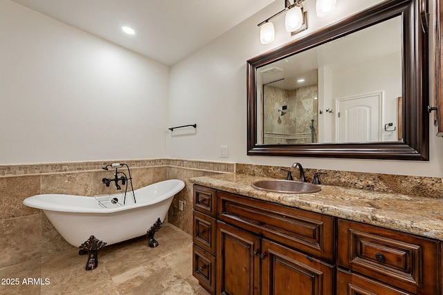 bathroom with tile walls, vanity, and separate shower and tub