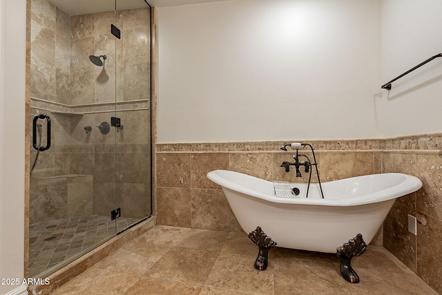 bathroom featuring plus walk in shower and tile walls