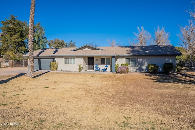 view of front of house featuring a garage and a front lawn