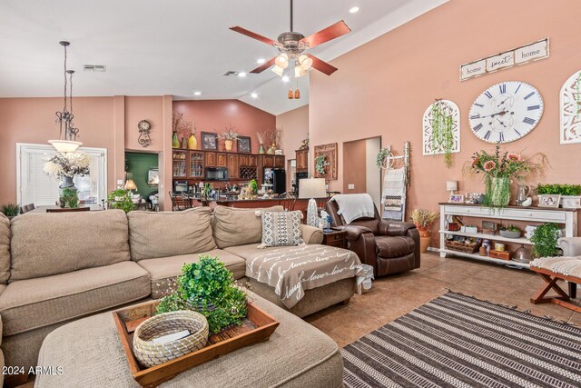 tiled living room featuring ceiling fan and high vaulted ceiling