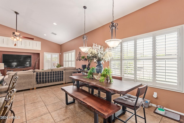 dining space featuring ceiling fan, lofted ceiling, plenty of natural light, and light tile patterned floors