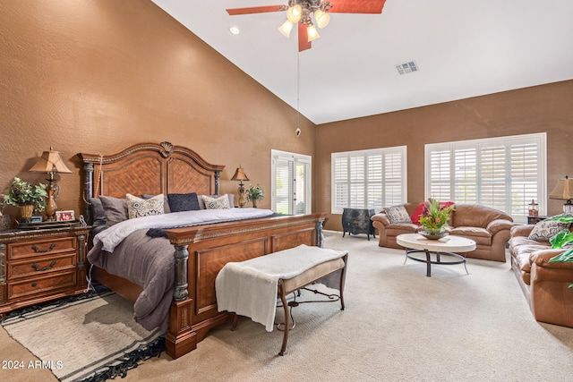 bedroom featuring light carpet, ceiling fan, and high vaulted ceiling