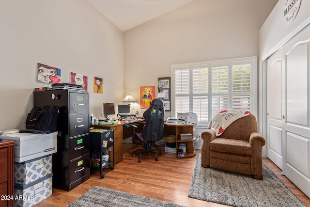 office featuring light hardwood / wood-style floors and high vaulted ceiling