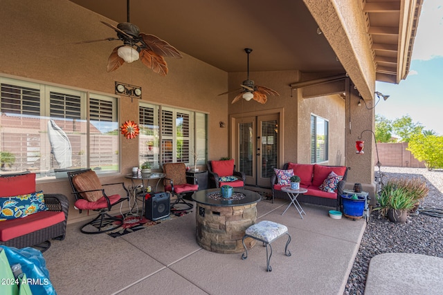 view of patio featuring an outdoor living space with a fire pit, ceiling fan, and french doors