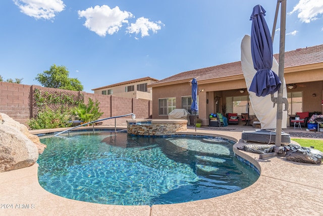 view of swimming pool featuring a patio and an in ground hot tub