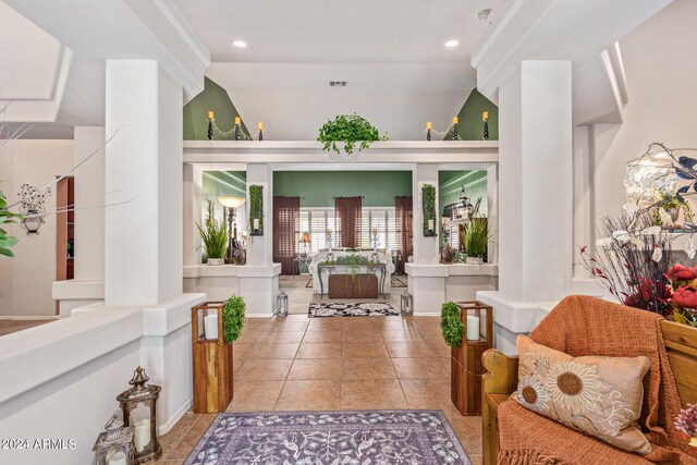 entrance foyer with lofted ceiling and light tile patterned floors