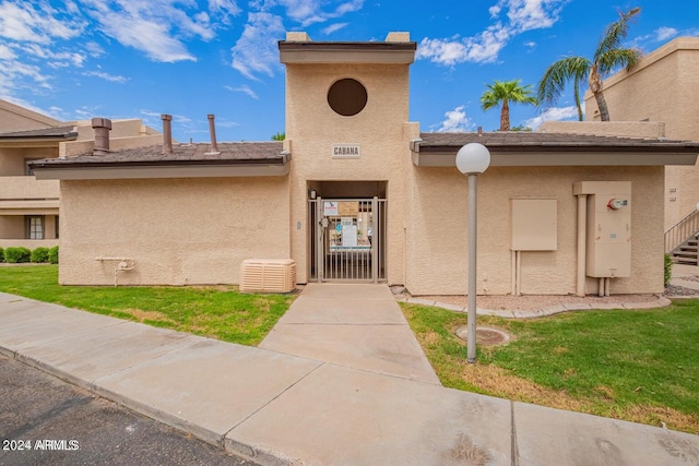 entrance to property featuring a lawn