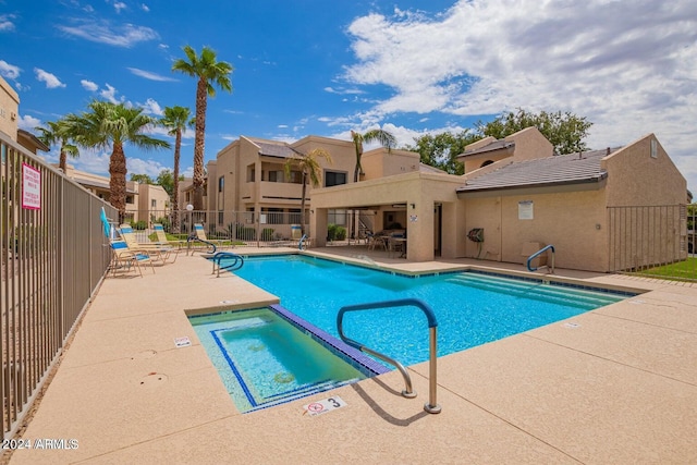 view of pool featuring a hot tub and a patio