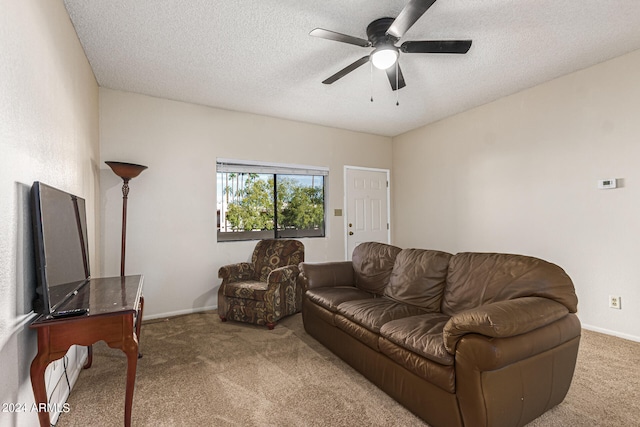 carpeted living room featuring a textured ceiling and ceiling fan