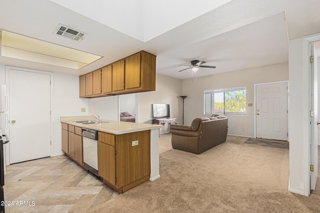 kitchen featuring sink, white dishwasher, kitchen peninsula, ceiling fan, and light colored carpet