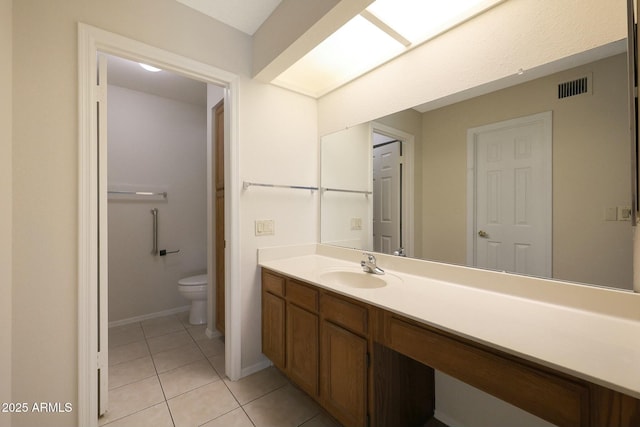 bathroom featuring tile patterned flooring, vanity, and toilet