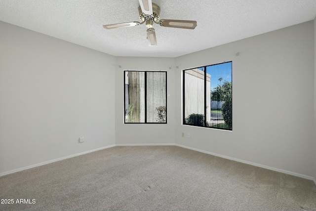 empty room featuring ceiling fan, carpet floors, and a textured ceiling