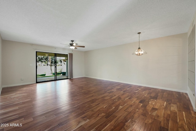 unfurnished room with a textured ceiling, dark hardwood / wood-style floors, and ceiling fan with notable chandelier