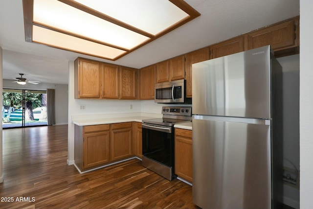 kitchen featuring dark hardwood / wood-style floors, ceiling fan, and stainless steel appliances