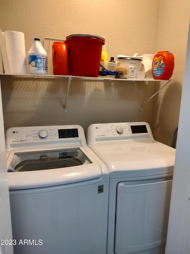 washroom featuring washing machine and clothes dryer