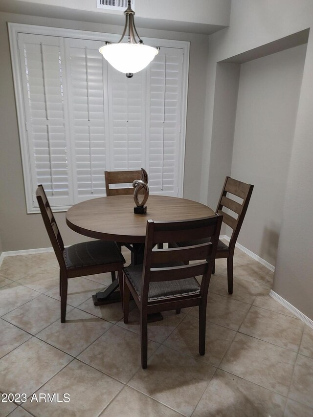 dining area featuring light tile patterned flooring