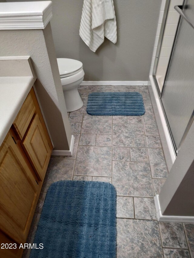 bathroom with toilet, tile patterned floors, and vanity