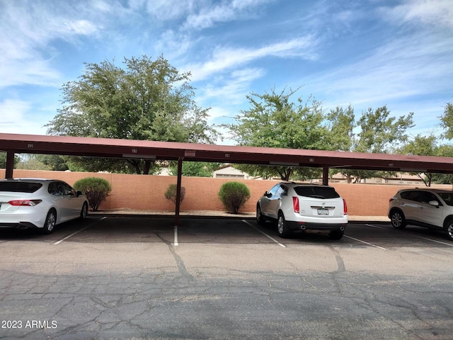 view of parking / parking lot featuring a carport