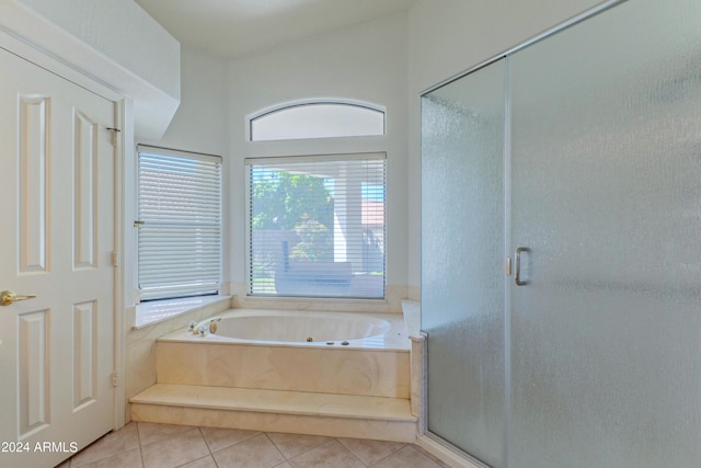 bathroom featuring tile patterned flooring and shower with separate bathtub