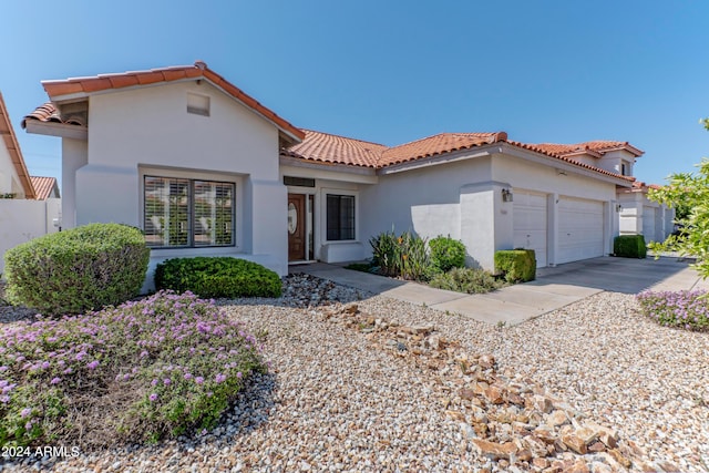 mediterranean / spanish home featuring a garage