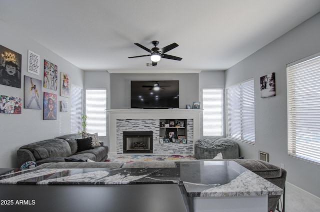 living room with ceiling fan and a wealth of natural light